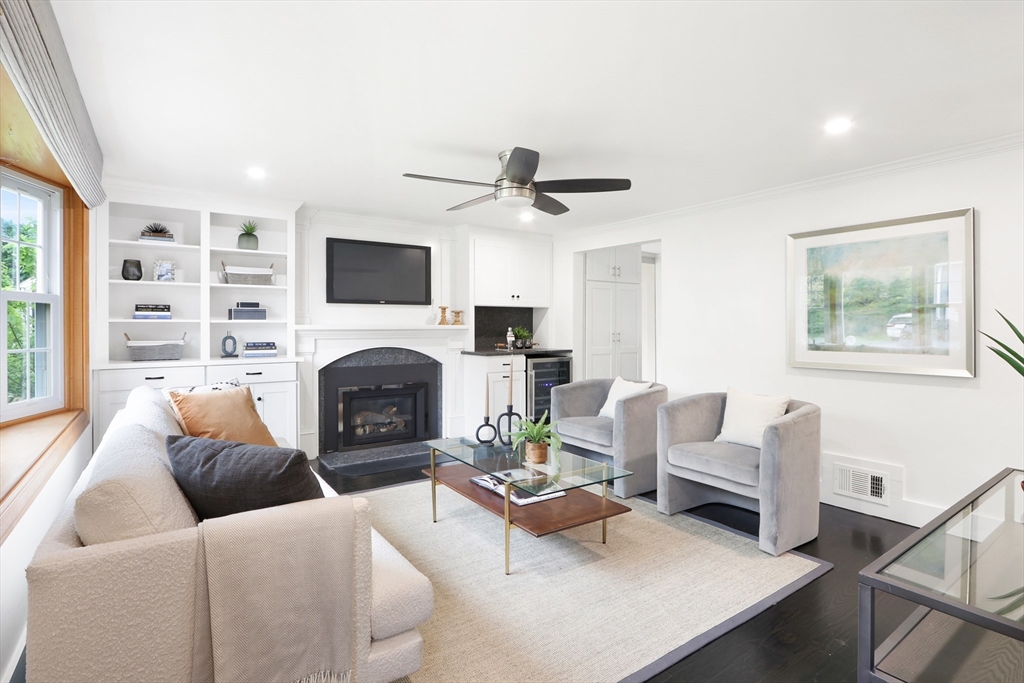 28 Longfellow Road Natick, MA 01760 - Photo 3 of 30 a living room with furniture a fireplace and a flat screen tv