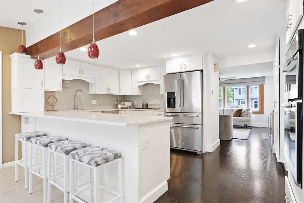 28 Longfellow Road Natick, MA 01760 - Photo 5 of 30 a kitchen with stainless steel appliances granite countertop a refrigerator oven stove a sink dishwasher and white cabinets with wooden floor