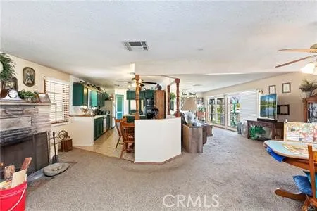 a living room with furniture and a kitchen