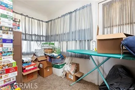 a living room filled with furniture and a large window
