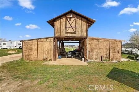 a view of a house with a swimming pool and a yard