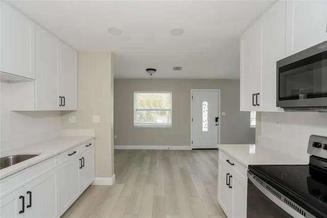 a view of a kitchen with electric appliances