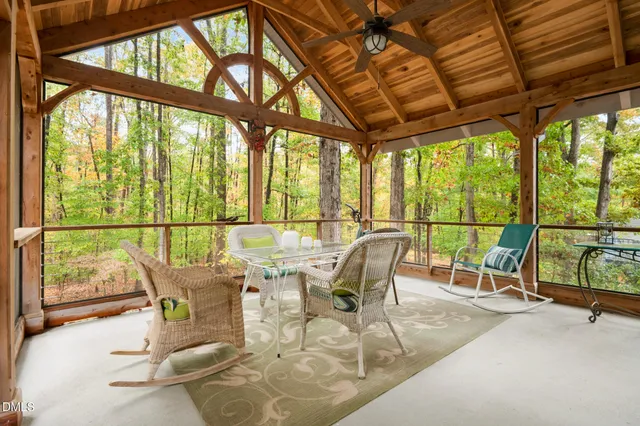 a dining room with wooden floor an outdoor seating and nature