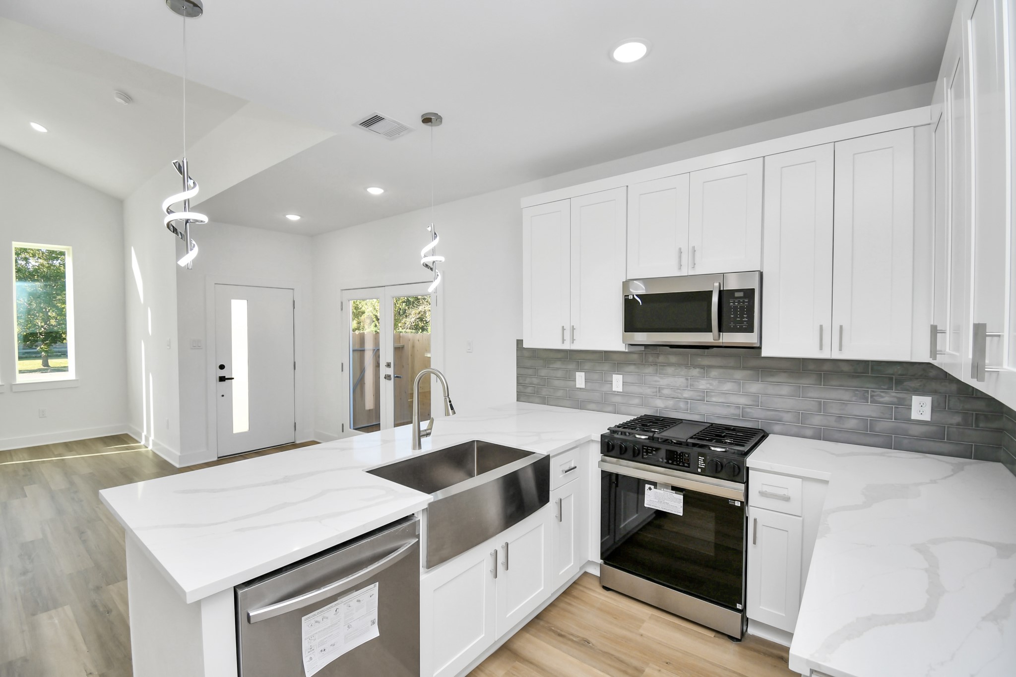 8109 Hamlet Street Houston, TX 77078 - Photo 14 of 50 a kitchen with stainless steel appliances white cabinets and wooden floor