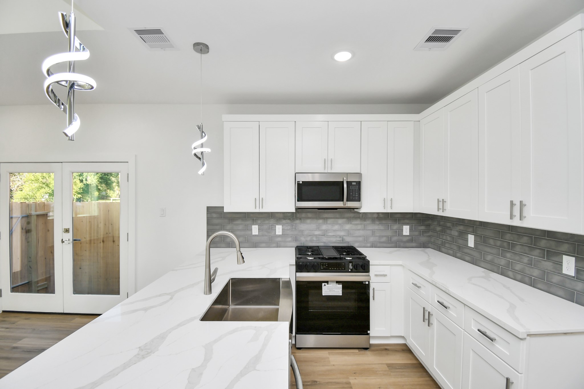 8109 Hamlet Street Houston, TX 77078 - Photo 15 of 50 a kitchen with stainless steel appliances granite countertop a stove a sink and a white cabinets
