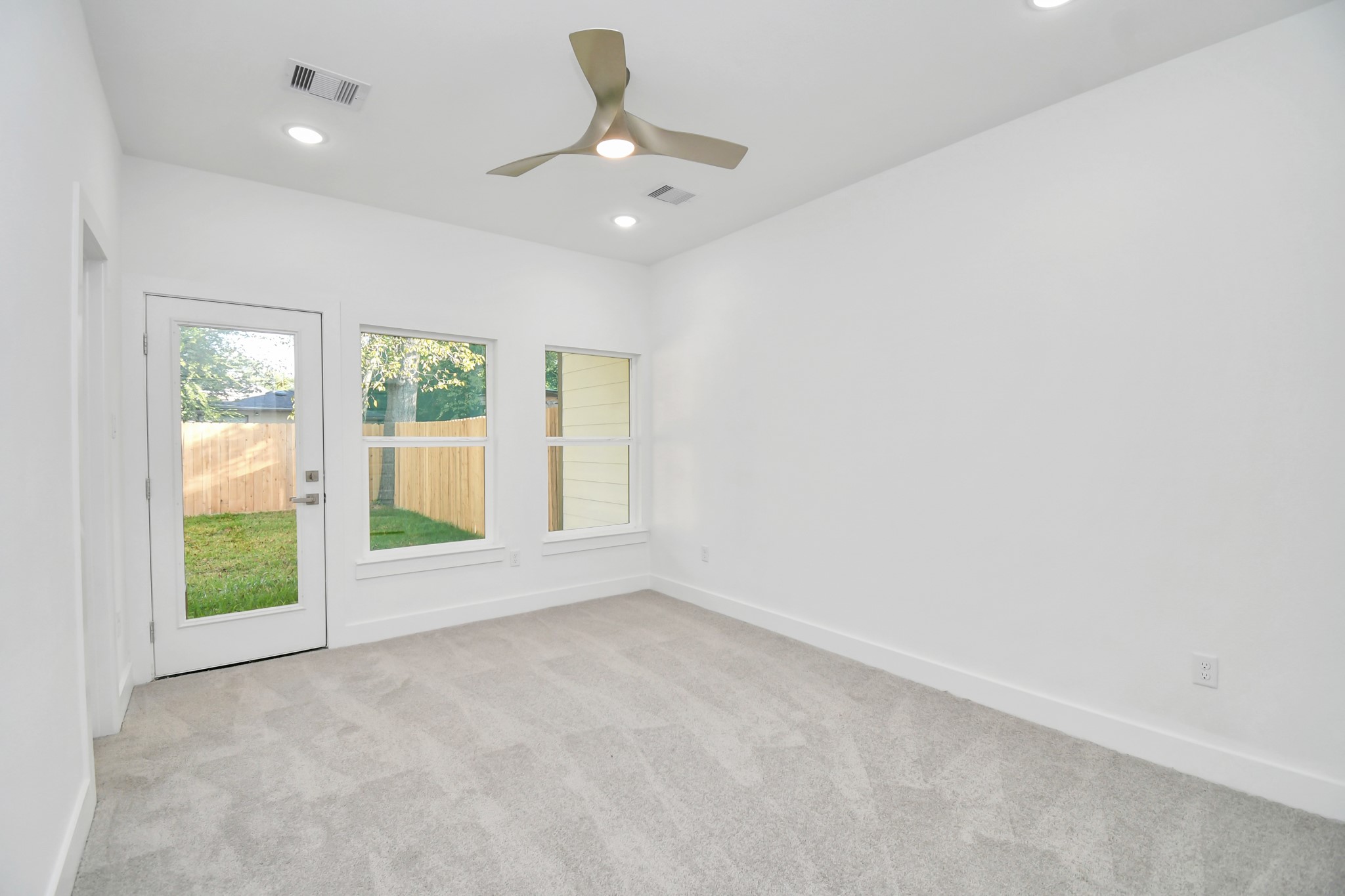 8109 Hamlet Street Houston, TX 77078 - Photo 22 of 50 an empty room with windows and outdoor view