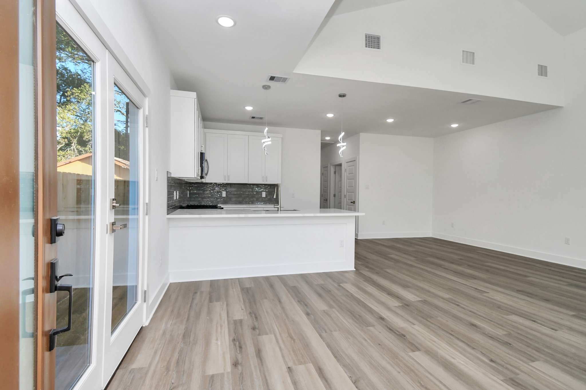 8109 Hamlet Street Houston, TX 77078 - Photo 9 of 50 a view of kitchen with kitchen island wooden floor center island and stainless steel appliances