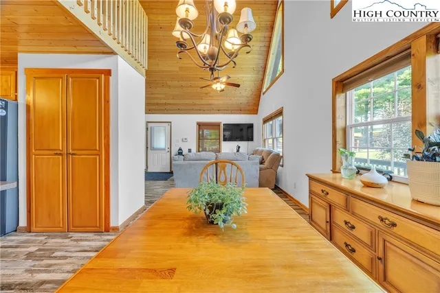 a kitchen with stainless steel appliances granite countertop a refrigerator a sink dishwasher a stove and white countertops with wooden floor