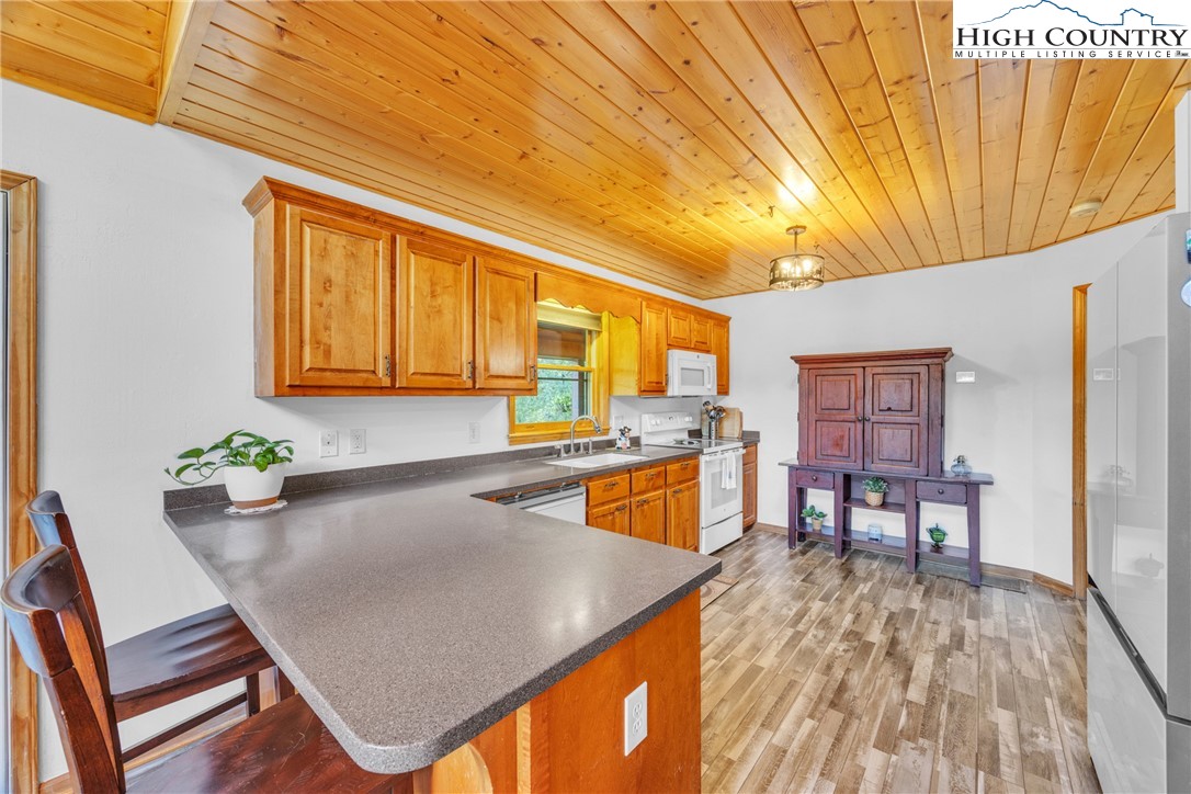 98 New Ridge Lane Piney Creek, NC 28663 - Photo 12 of 50 a room with furniture and wooden floor