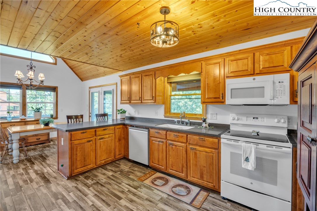 98 New Ridge Lane Piney Creek, NC 28663 - Photo 14 of 50 a kitchen with stainless steel appliances granite countertop a sink and cabinets