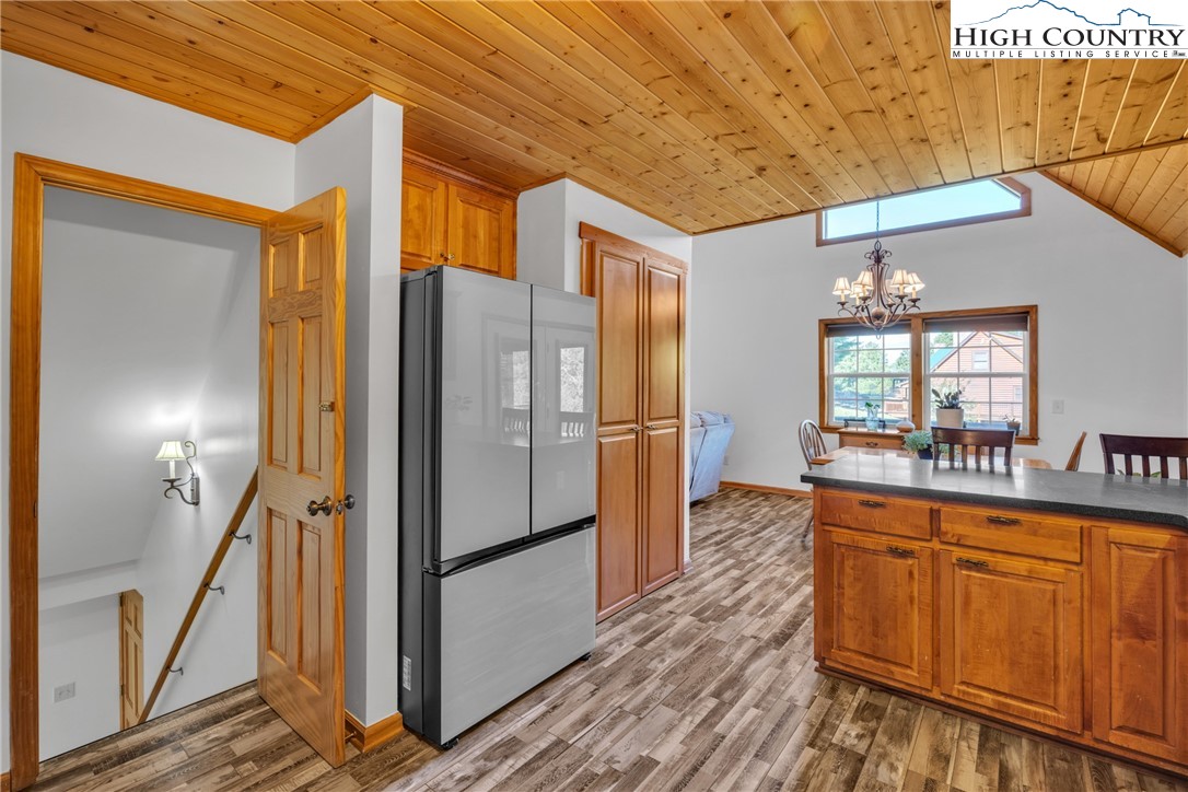 98 New Ridge Lane Piney Creek, NC 28663 - Photo 15 of 50 a kitchen with stainless steel appliances granite countertop a refrigerator a sink and wooden cabinets