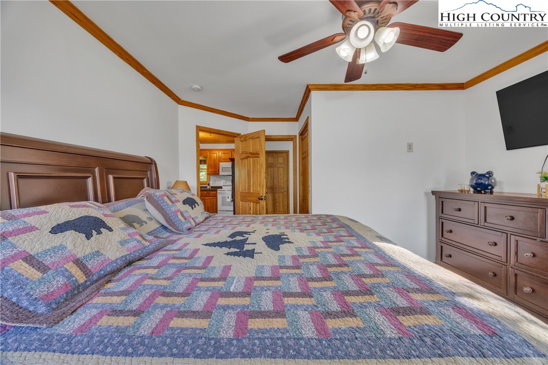 98 New Ridge Lane Piney Creek, NC 28663 - Photo 18 of 50 a bedroom with a bed and a flat screen tv