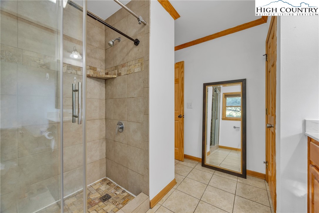 98 New Ridge Lane Piney Creek, NC 28663 - Photo 20 of 50 a bathroom with a shower and a sink