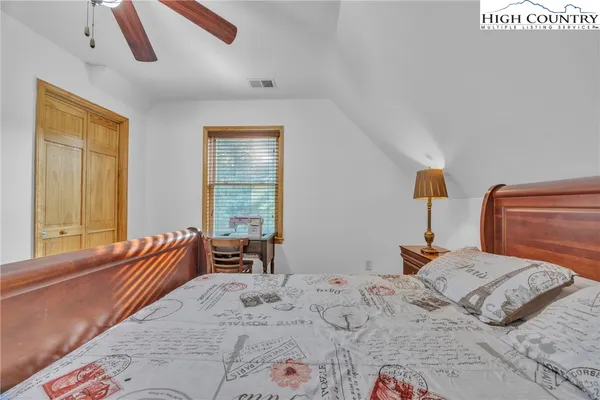 a bathroom with a sink a toilet a mirror a vanity and shower