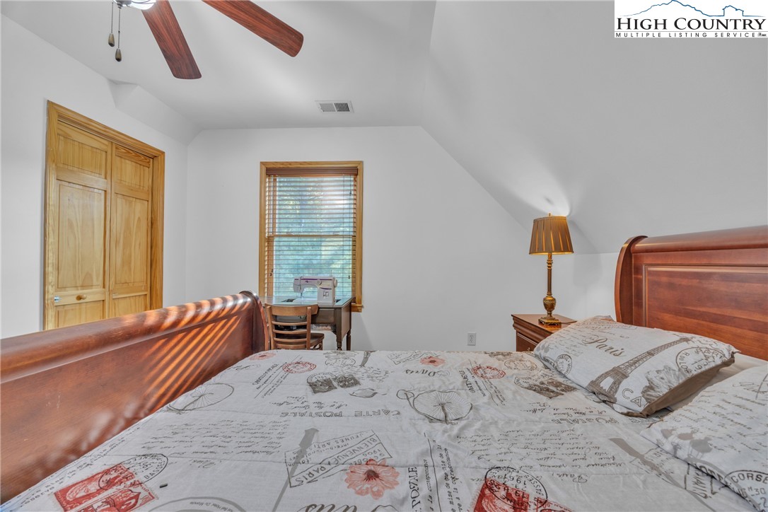 98 New Ridge Lane Piney Creek, NC 28663 - Photo 24 of 50 a bedroom with a bed and a window