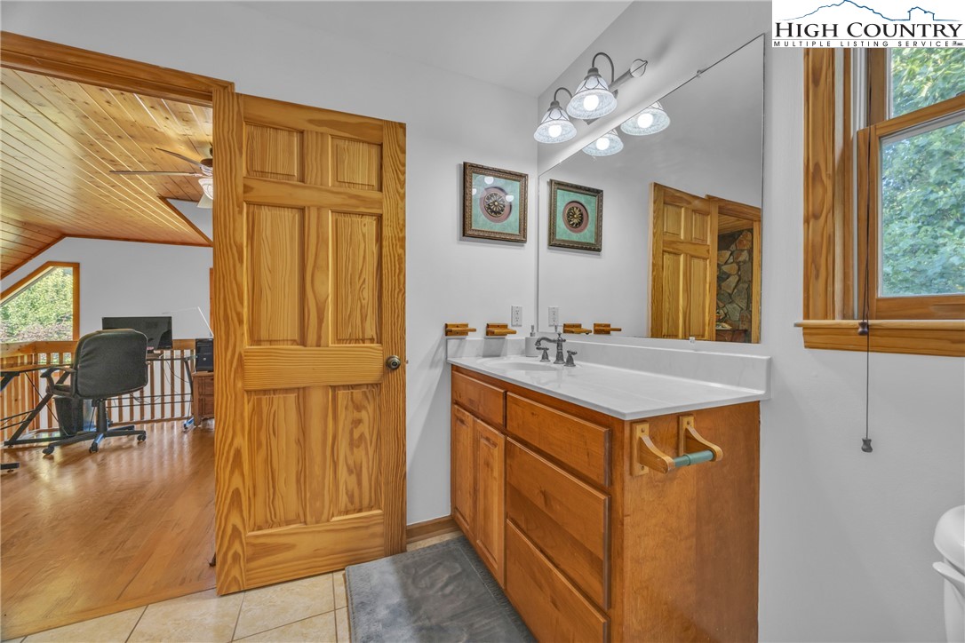 98 New Ridge Lane Piney Creek, NC 28663 - Photo 27 of 50 a bathroom with a sink a vanity and a mirror