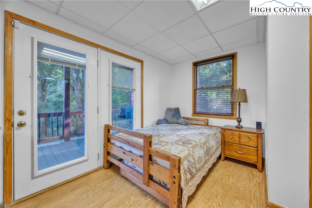 98 New Ridge Lane Piney Creek, NC 28663 - Photo 29 of 50 a bed sitting in a bedroom next to a window