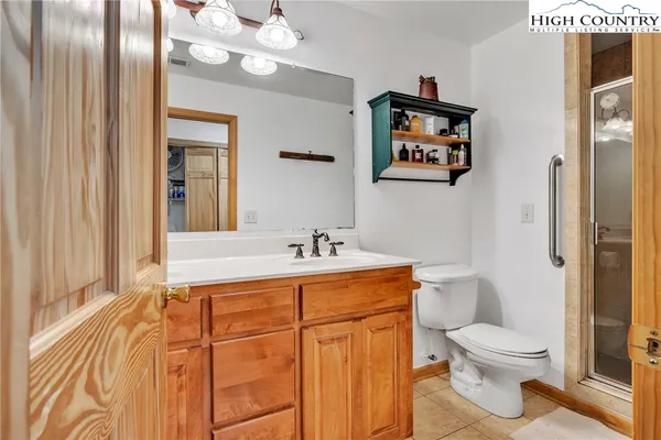 a bathroom with a sink a mirror and a shower