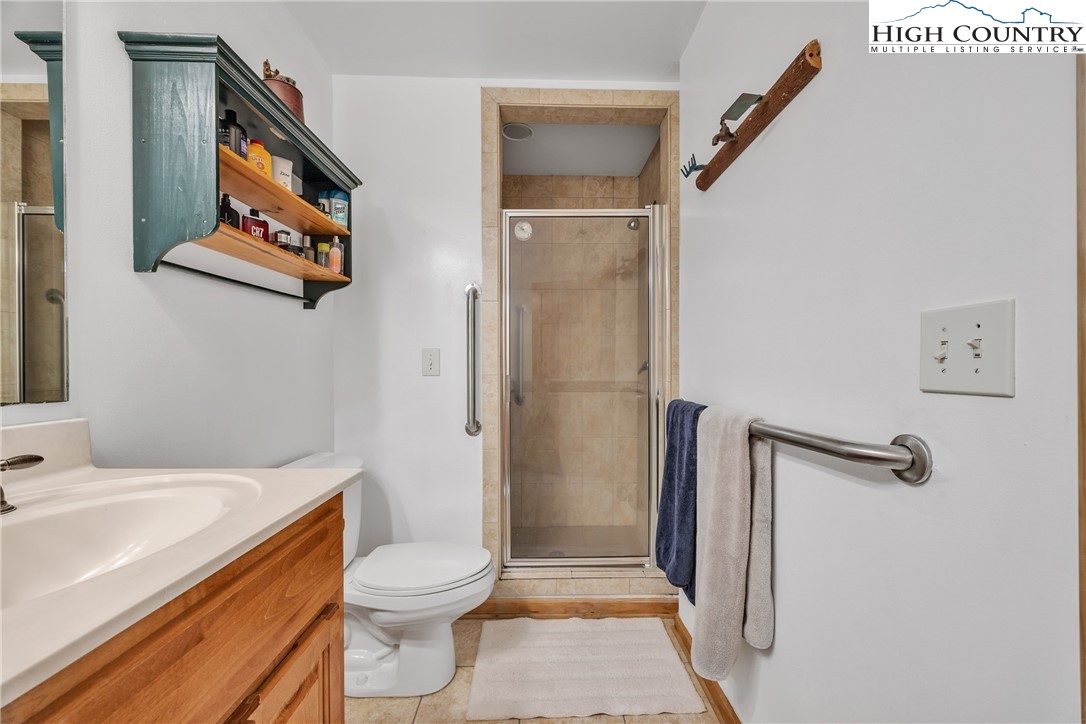 98 New Ridge Lane Piney Creek, NC 28663 - Photo 33 of 50 a bathroom with a sink a toilet and shower