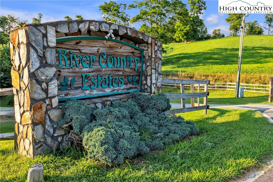98 New Ridge Lane Piney Creek, NC 28663 - Photo 48 of 50 a view of a swimming pool with a garden and trees
