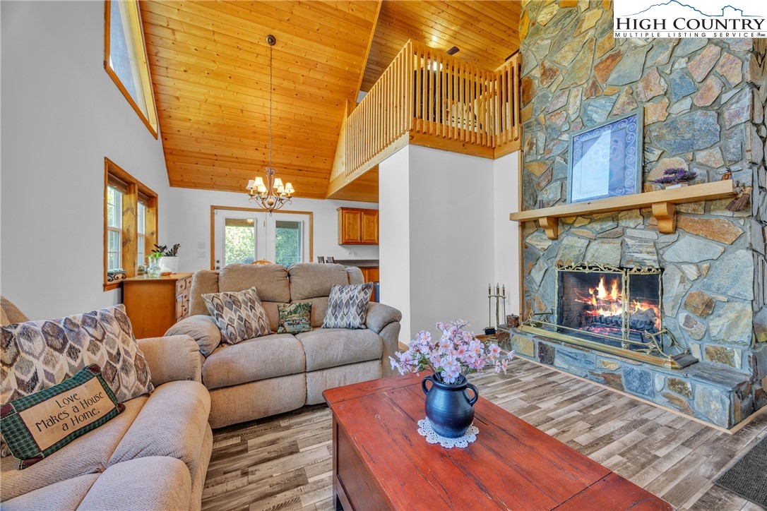 98 New Ridge Lane Piney Creek, NC 28663 - Photo 7 of 50 a living room with furniture flowers and a fireplace