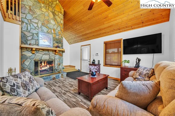 a view of a dining room with furniture and a chandelier