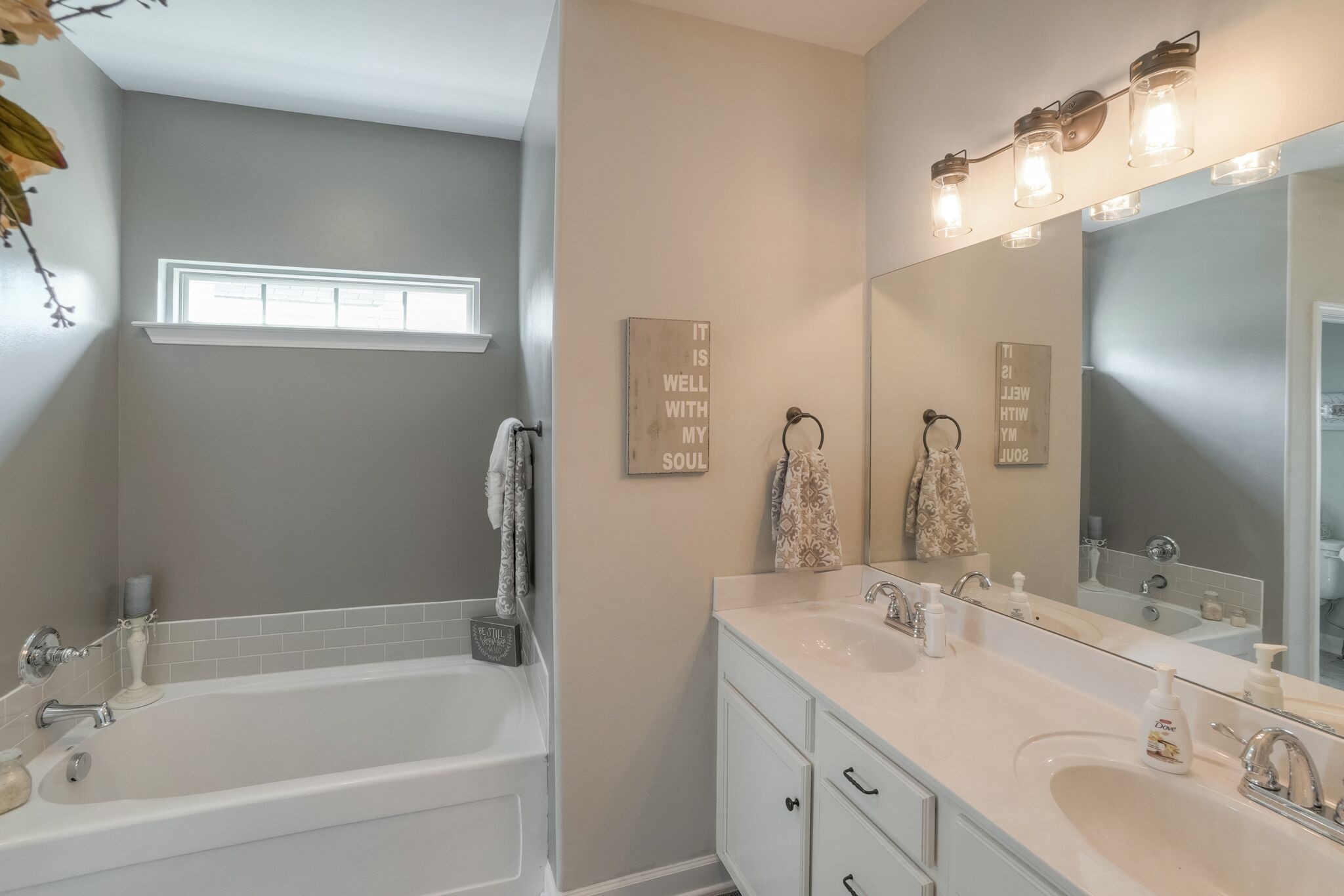 1057 Golf View Way Spring Hill, TN 37174 - Photo 16 of 29 a bathroom with a tub a sink and mirror