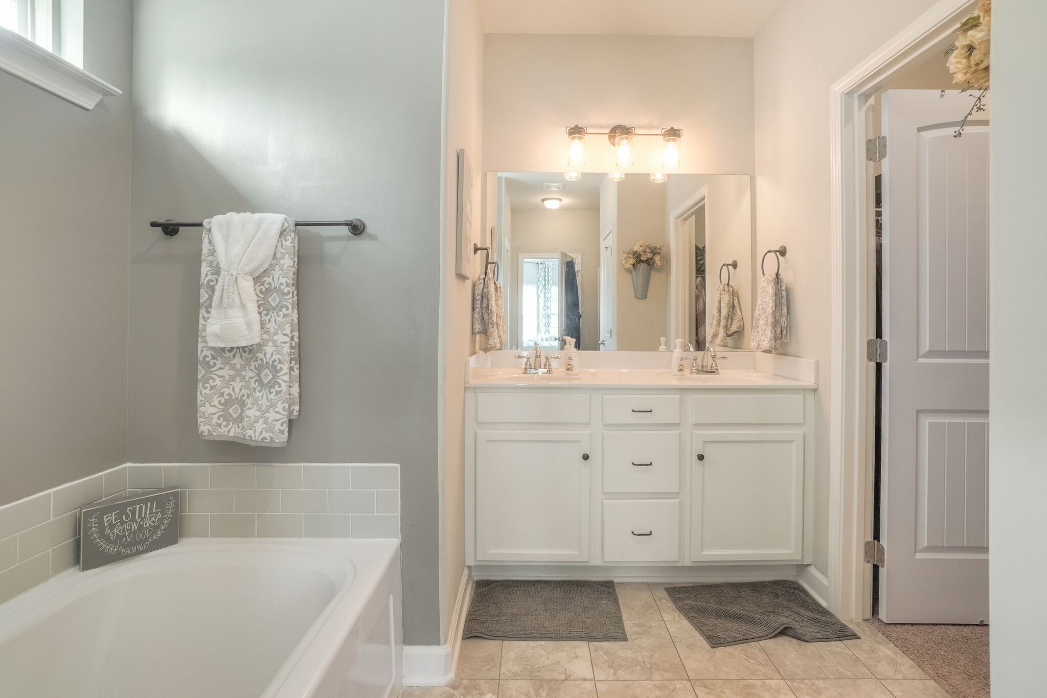 1057 Golf View Way Spring Hill, TN 37174 - Photo 18 of 29 a bathroom with a tub sink and mirror