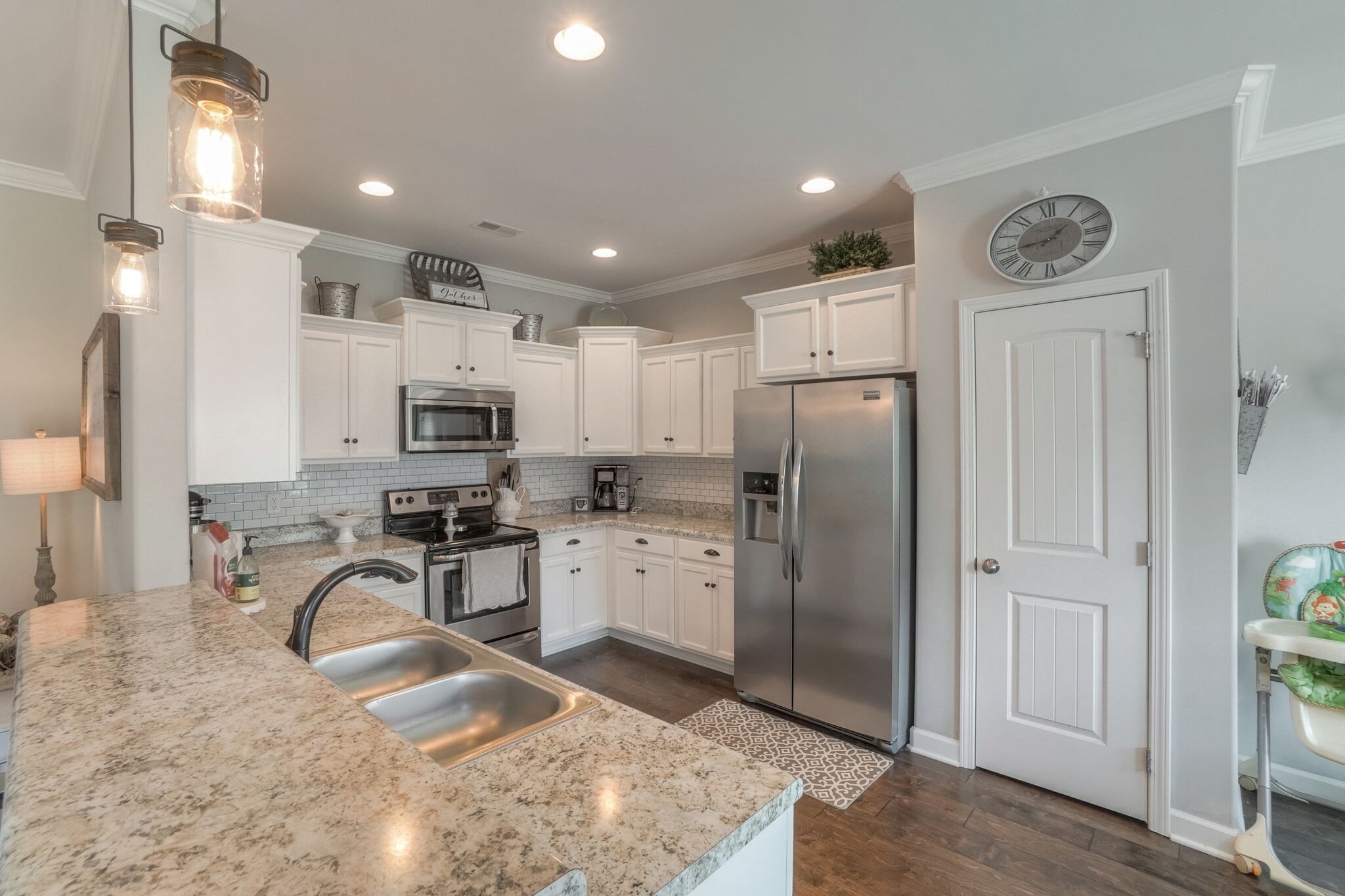 1057 Golf View Way Spring Hill, TN 37174 - Photo 9 of 29 a kitchen with stainless steel appliances granite countertop a refrigerator a stove and a sink with wooden floor