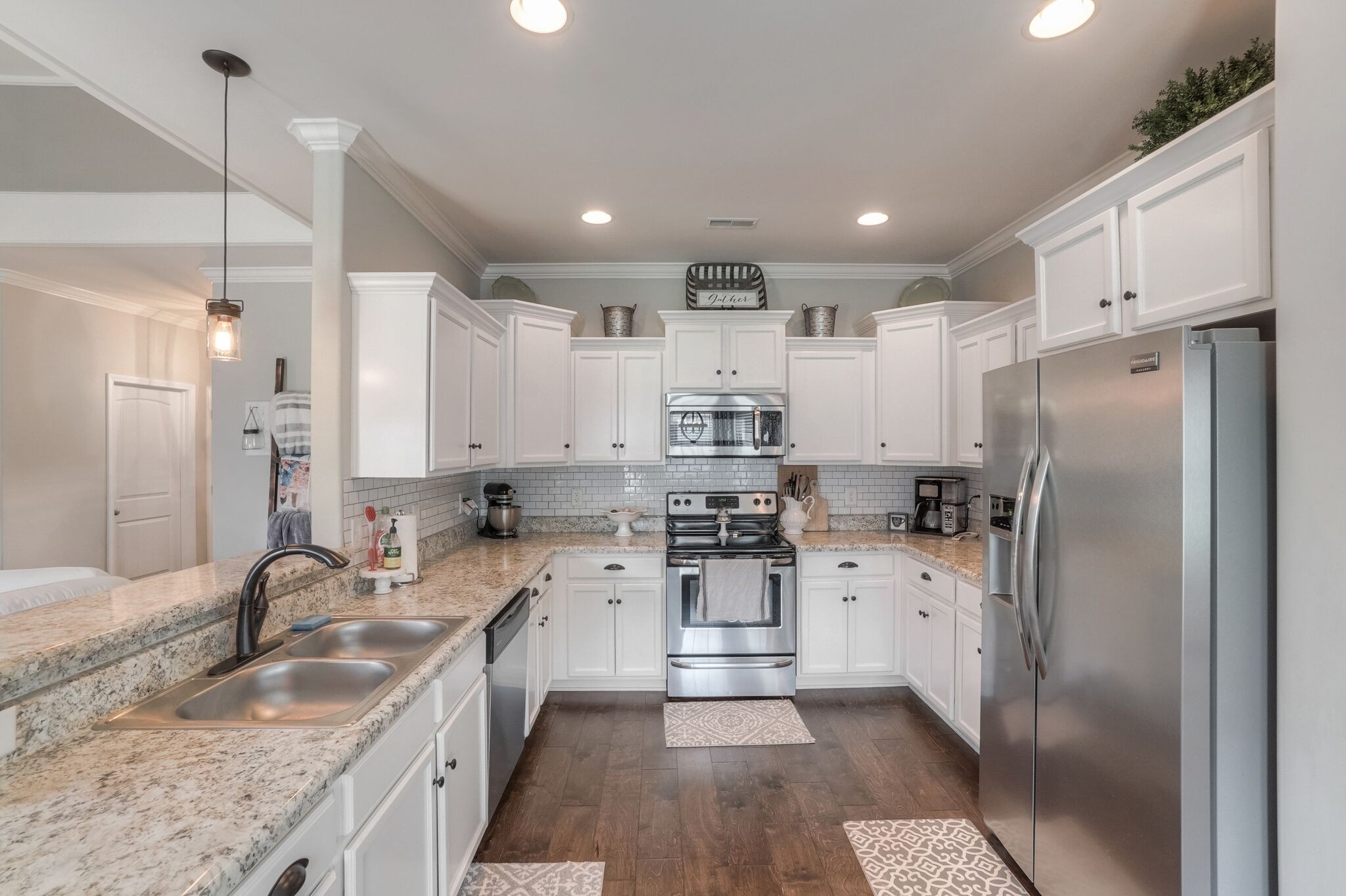 1057 Golf View Way Spring Hill, TN 37174 - Photo 10 of 29 a kitchen with granite countertop a sink a counter space appliances and cabinets