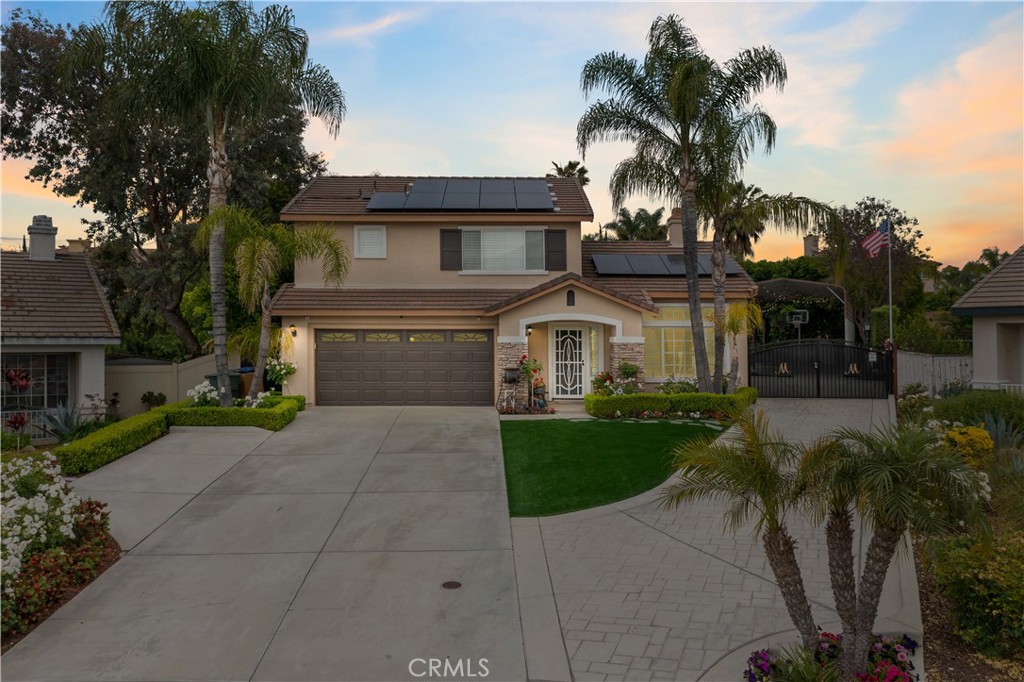 1327 Sutherland Drive Riverside, CA 92507 - Photo 1 of 1 a front view of a house with garden and trees