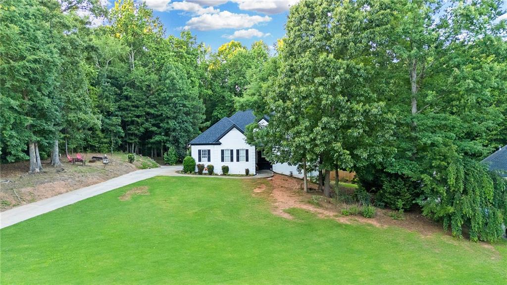 151 Dumar Lane Hoschton, GA 30548 - Photo 3 of 69 a view of a house with a yard and large trees