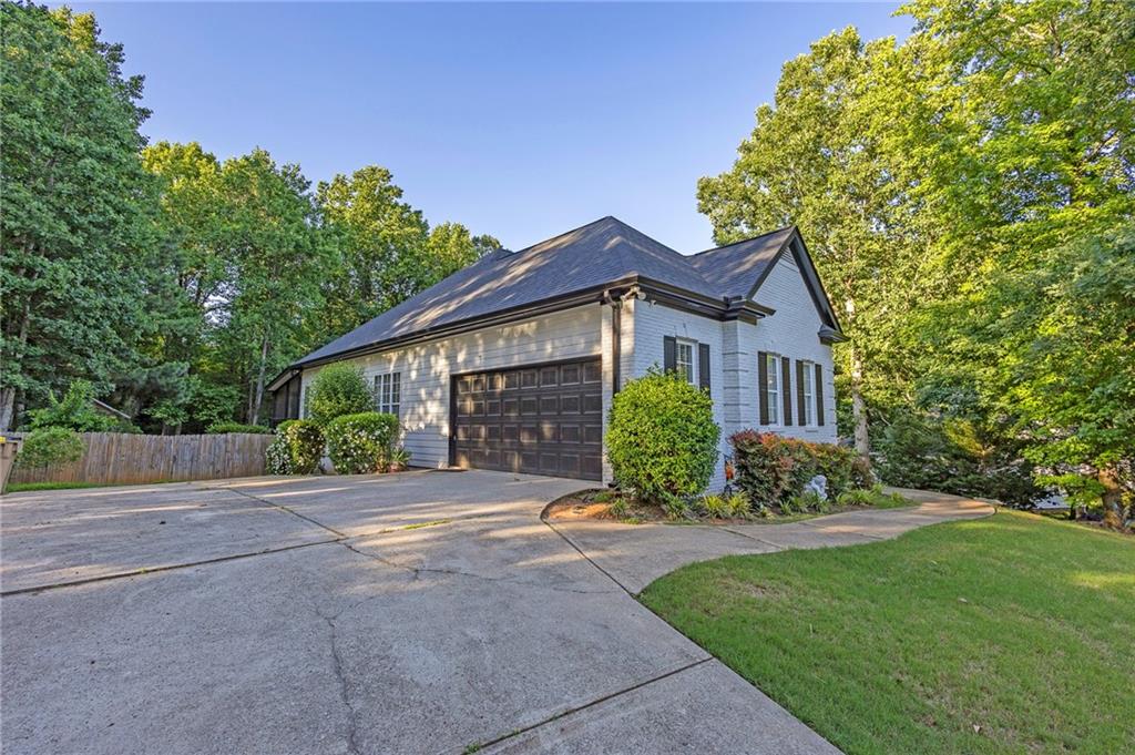 151 Dumar Lane Hoschton, GA 30548 - Photo 4 of 69 a front view of a house with a garden and yard