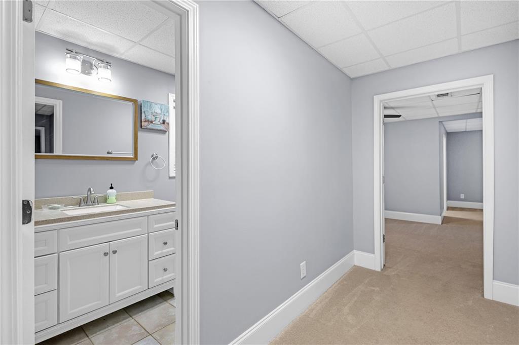 151 Dumar Lane Hoschton, GA 30548 - Photo 51 of 69 a en suite bathroom with a granite countertop sink and a mirror