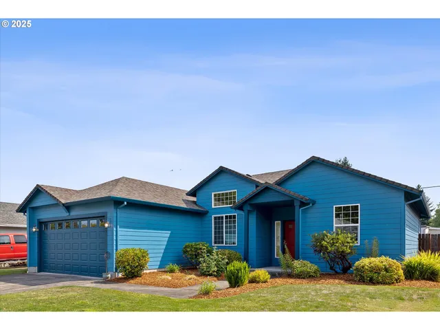 a view of house with yard and front view of a house