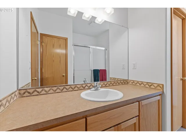 a bathroom with a sink vanity and a mirror