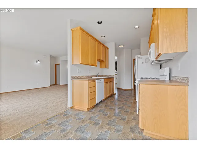 a kitchen with stainless steel appliances granite countertop a sink and a stove