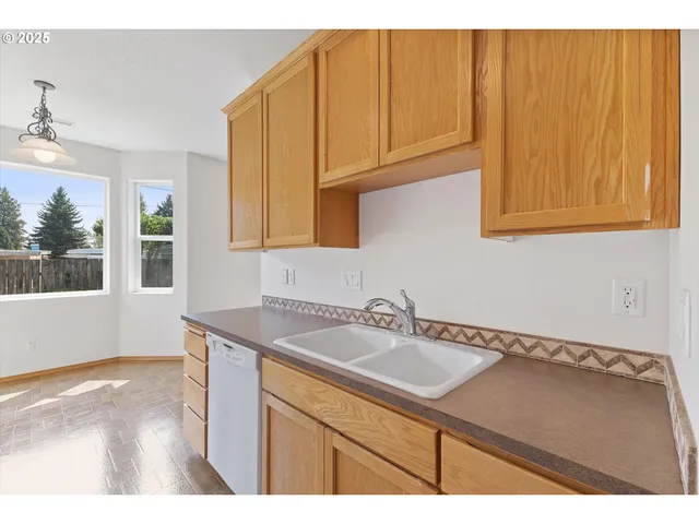 a kitchen with a sink cabinets and a window