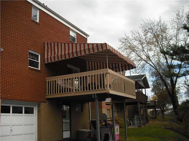Exterior Front. Rear cover deck with canvas awning off first floor family room.