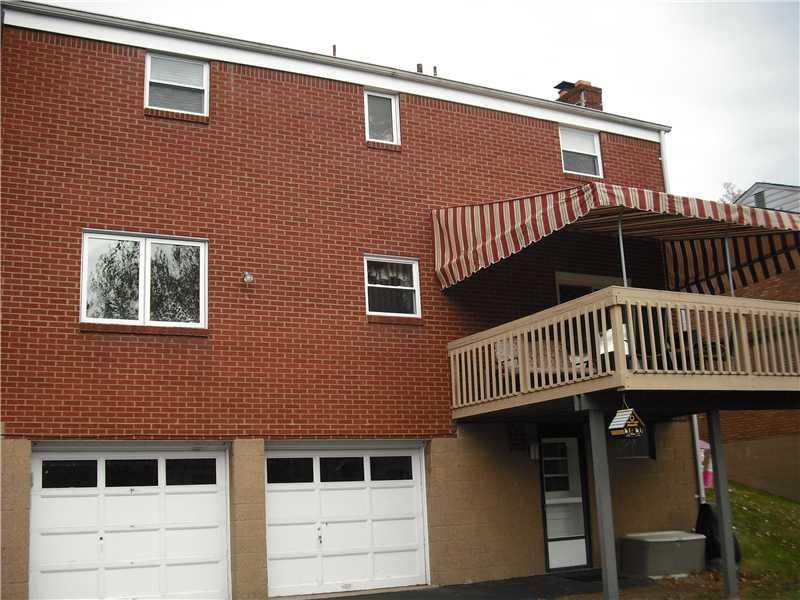 Exterior Back. View of exterior back showing the covered deck, 2 car integral garage with ample in driveway for turn around of vehicals. Nice sold brick exterior.