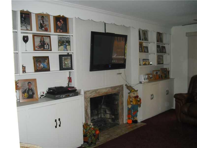 2483 Rose Garden Road Pittsburgh, PA 15220 - Photo 23 of 25 Family Room. View of fireplace and built in shelving/storage in the first floor family room.