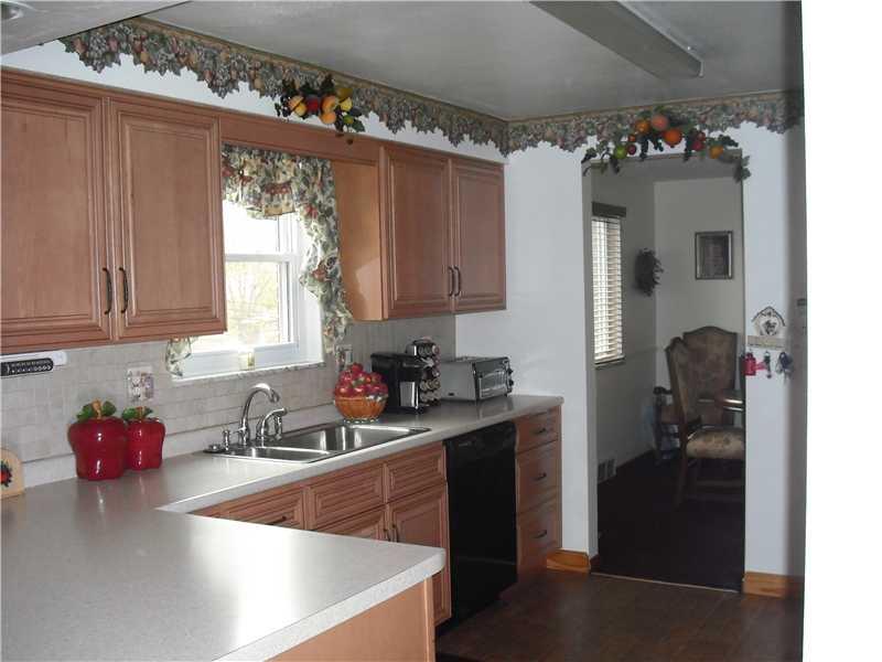 Kitchen. Fabulous newer kitchen with ample cabinet and counter space including refrigerator, dishwasher, electric stove, disposal system and built in microwave oven and laminate floating floor.