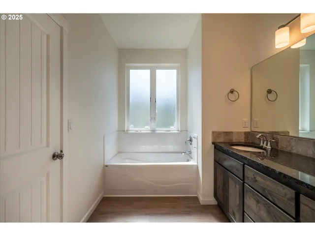 a bathroom with a bathtub and a sink