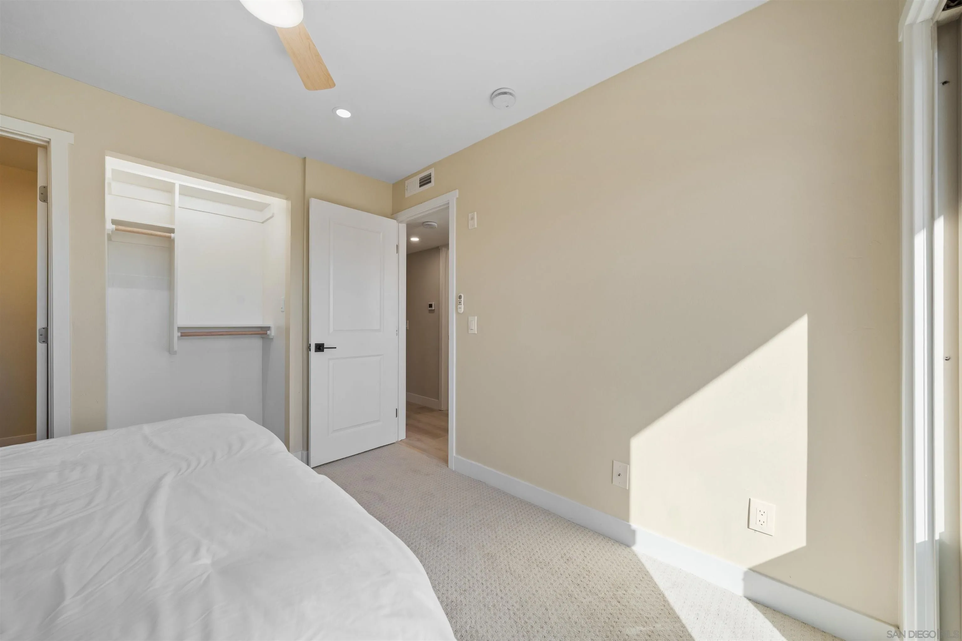 4521 55th Street, Unit 13 San Diego, CA 92115 - Photo 15 of 26 a bedroom with a bed and a large window