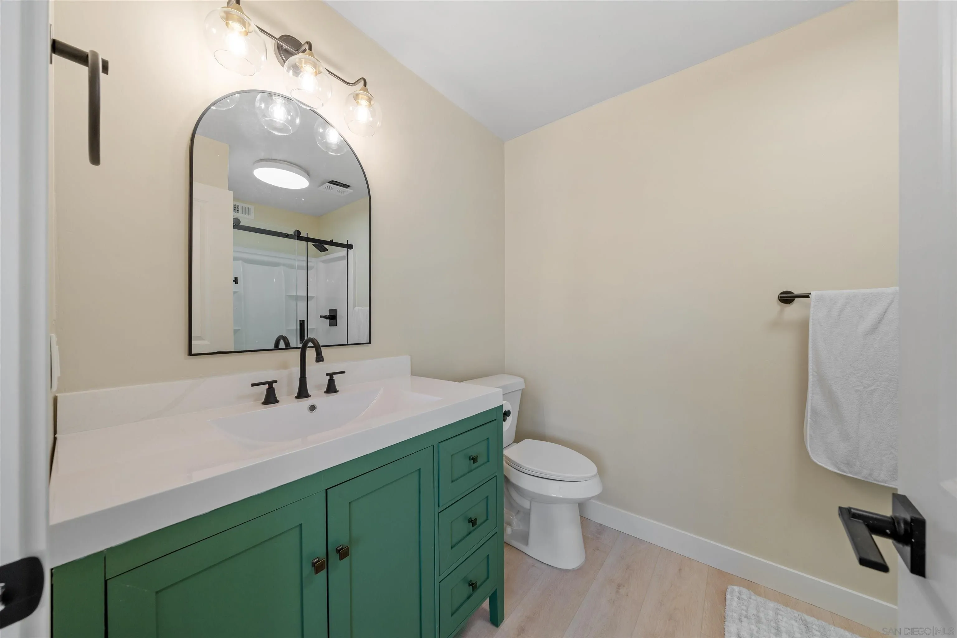 4521 55th Street, Unit 13 San Diego, CA 92115 - Photo 17 of 26 a bathroom with a toilet sink and mirror