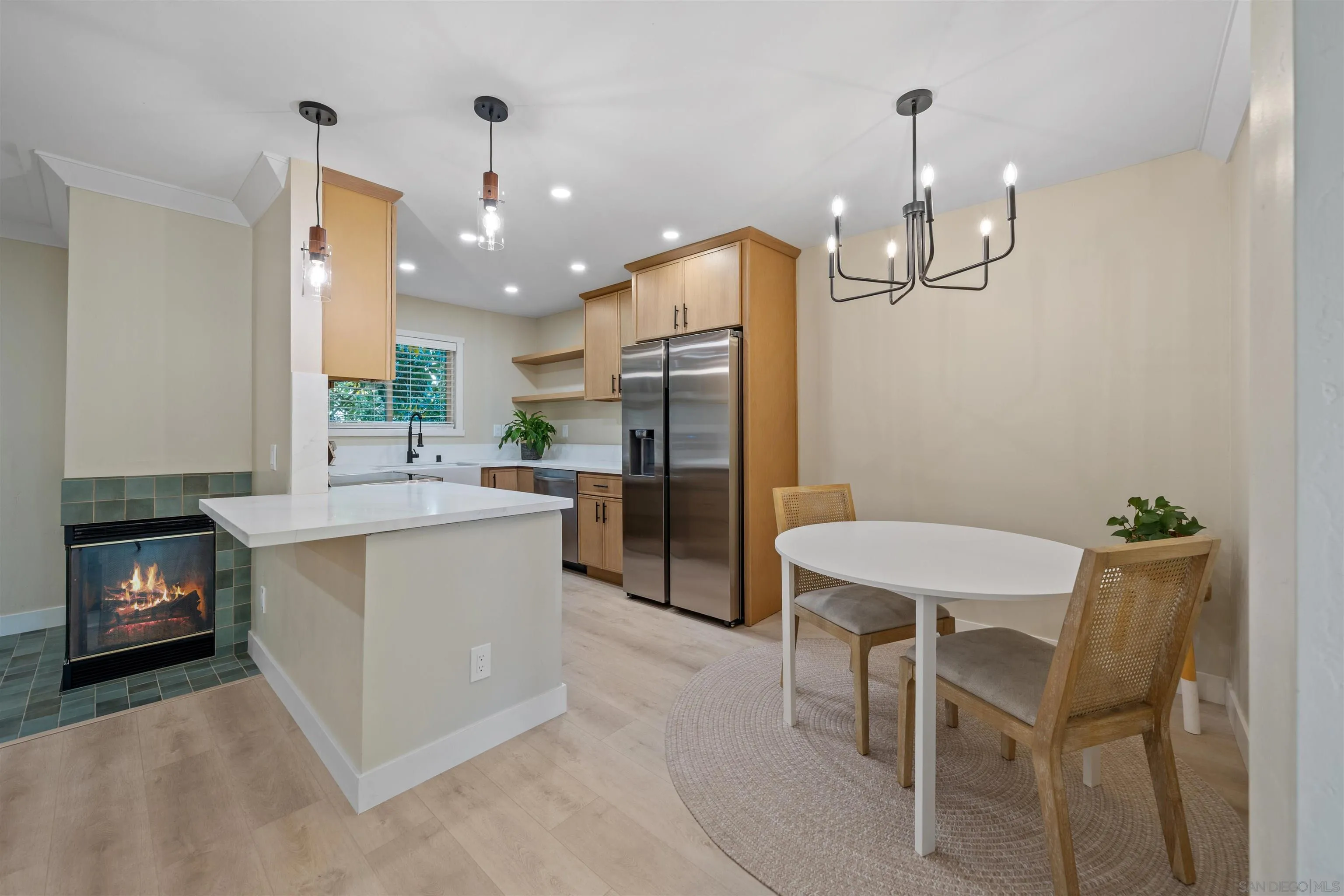 4521 55th Street, Unit 13 San Diego, CA 92115 - Photo 2 of 26 a kitchen with a table chairs sink and refrigerator