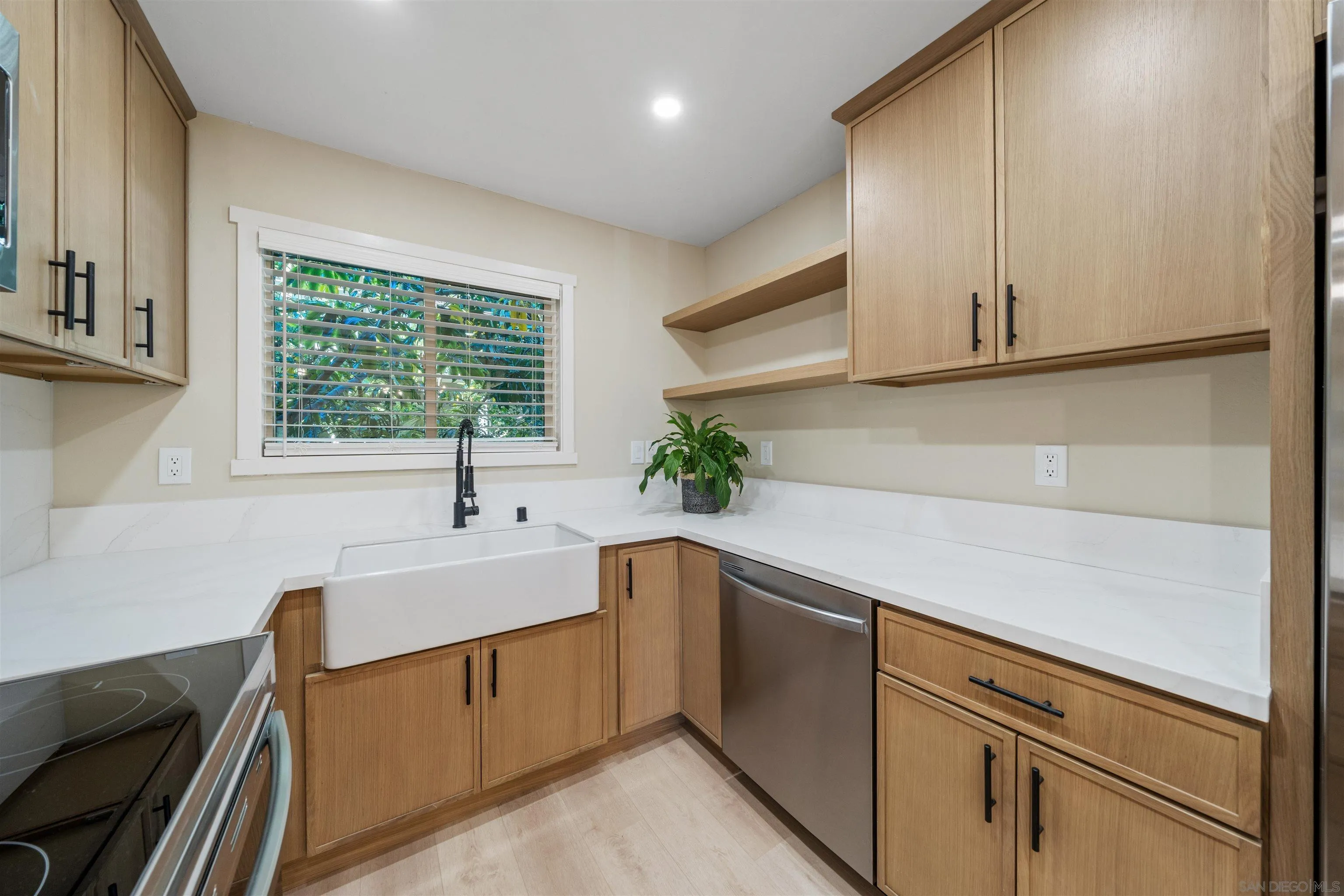 4521 55th Street, Unit 13 San Diego, CA 92115 - Photo 8 of 26 a kitchen with stainless steel appliances sink a microwave and cabinets