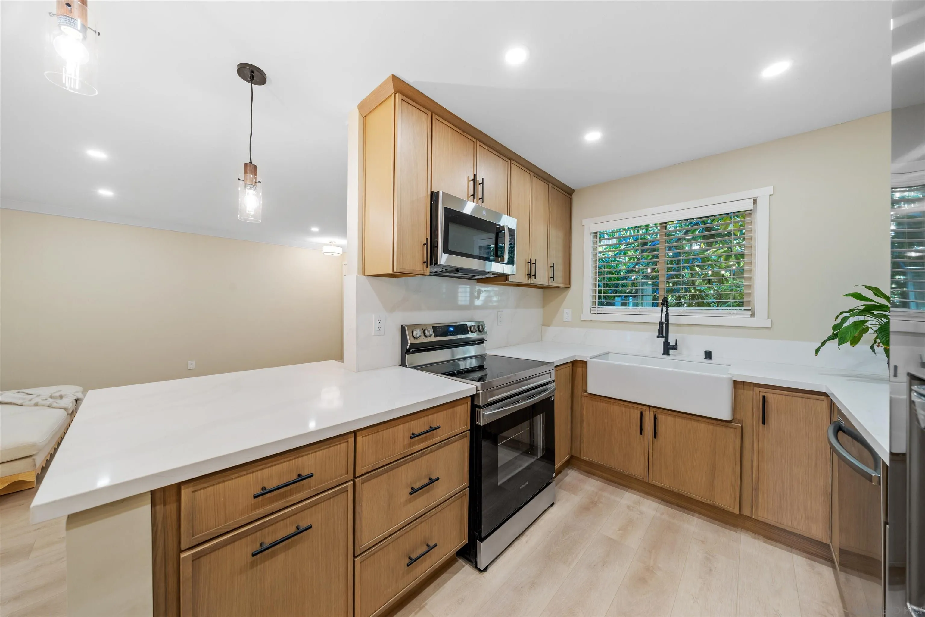 4521 55th Street, Unit 13 San Diego, CA 92115 - Photo 9 of 26 a kitchen with granite countertop a sink stainless steel appliances and cabinets