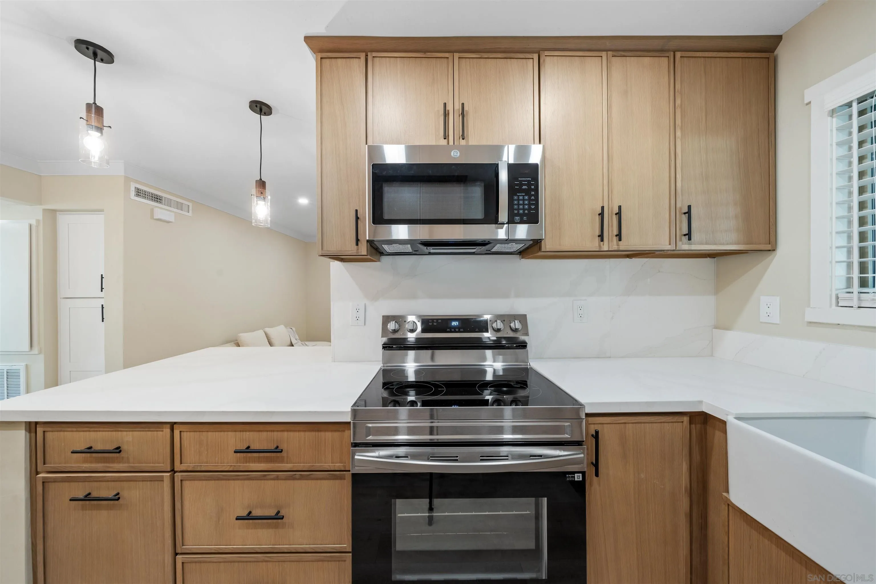 4521 55th Street, Unit 13 San Diego, CA 92115 - Photo 10 of 26 a kitchen with a stove and a microwave
