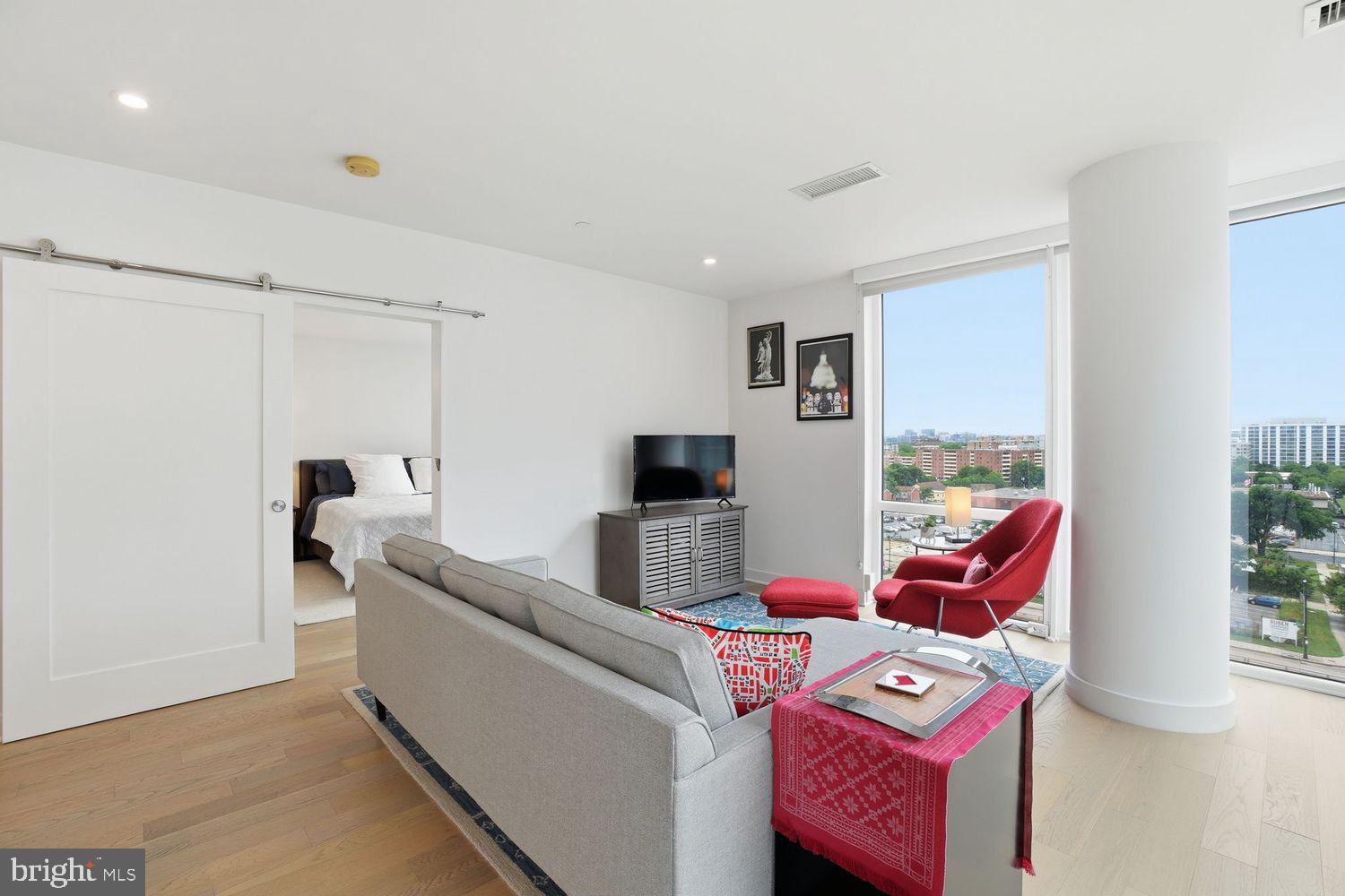 37 L Street Southeast, Unit 902 Washington, DC 20003 - Photo 11 of 43 a living room with furniture and a flat screen tv